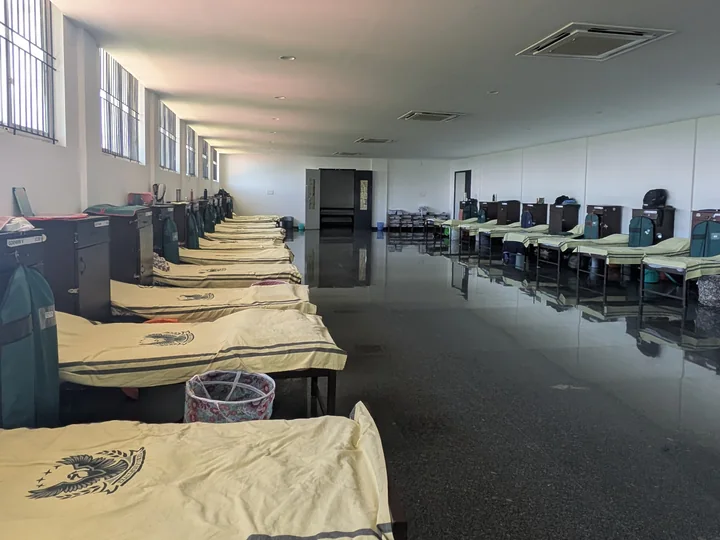 Rows of individual beds and storage cupboards in the boys’ hostel at Greenhills